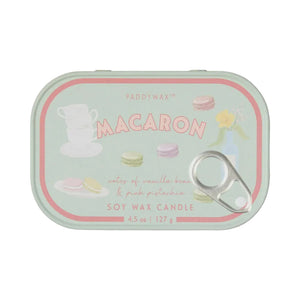 A Paddywax Macaron soy wax candle in a mint green tin with pink and pastel macaron illustrations and a silver pull tab, shown on a light gray background.