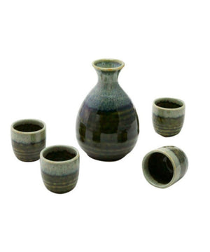 A ceramic sake set with a small bottle and four cups in a dark green and gray glaze, arranged on a plain white background.